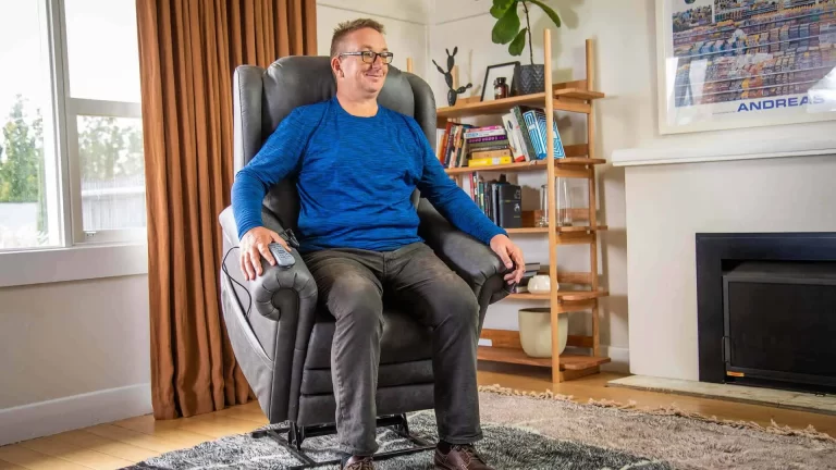 Lifestyle photography by Admedia showing a man comfortably using a K Care Alivio lift chair in a home setting, highlighting content creation for K Care products.