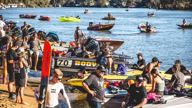 Admedia content creation: a vibrant scene at a Mildura Ski Club event, showing numerous ski boats and spectators along the Murray River bank.