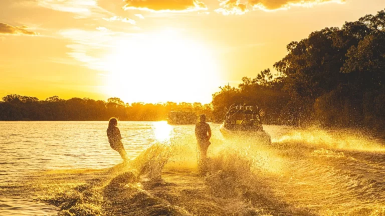 Lifestyle content creation by Admedia for Mildura Ski Club: two people skiing on the Murray River in front of a golden sunset.