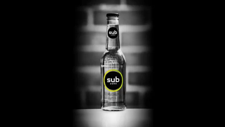 Single Sub Zero citrus vodka mix bottle with black and yellow branding against blurred background with dramatic lighting